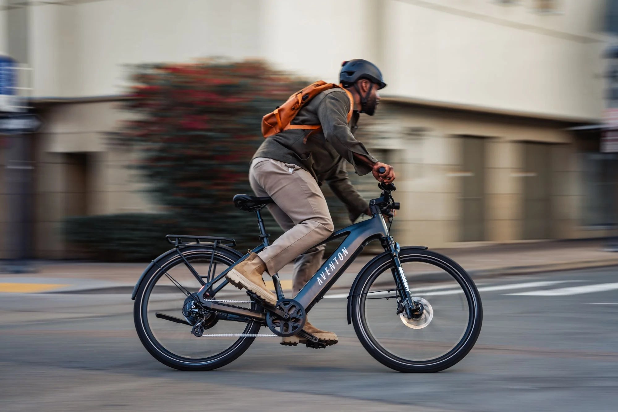 Men riding on the Aventon Level 3 E-Bike through the city