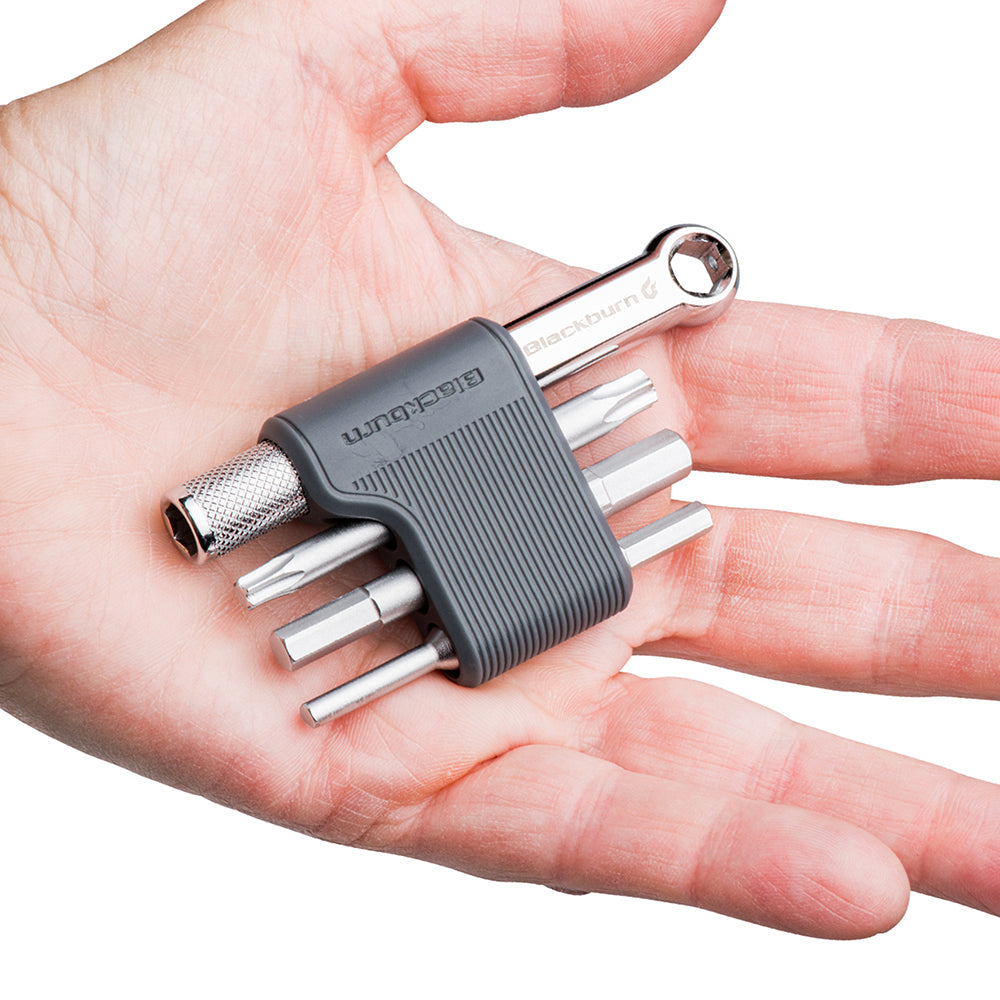 Hand holding a compact blackburn mini tool size kit