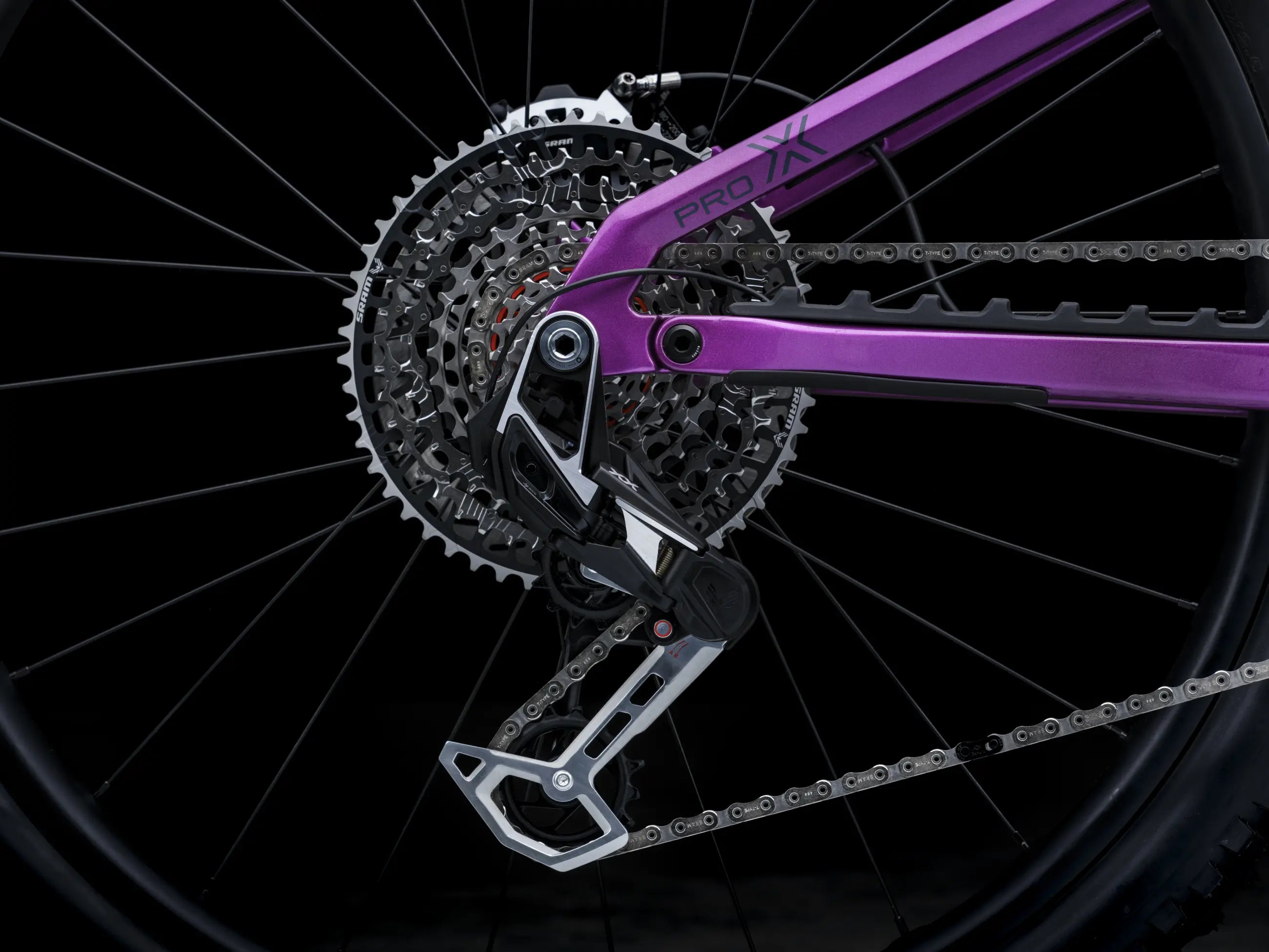 Close-up of Crussis e-Full 12.11 Pro X E-MTB chainset with gear and chain on a black background