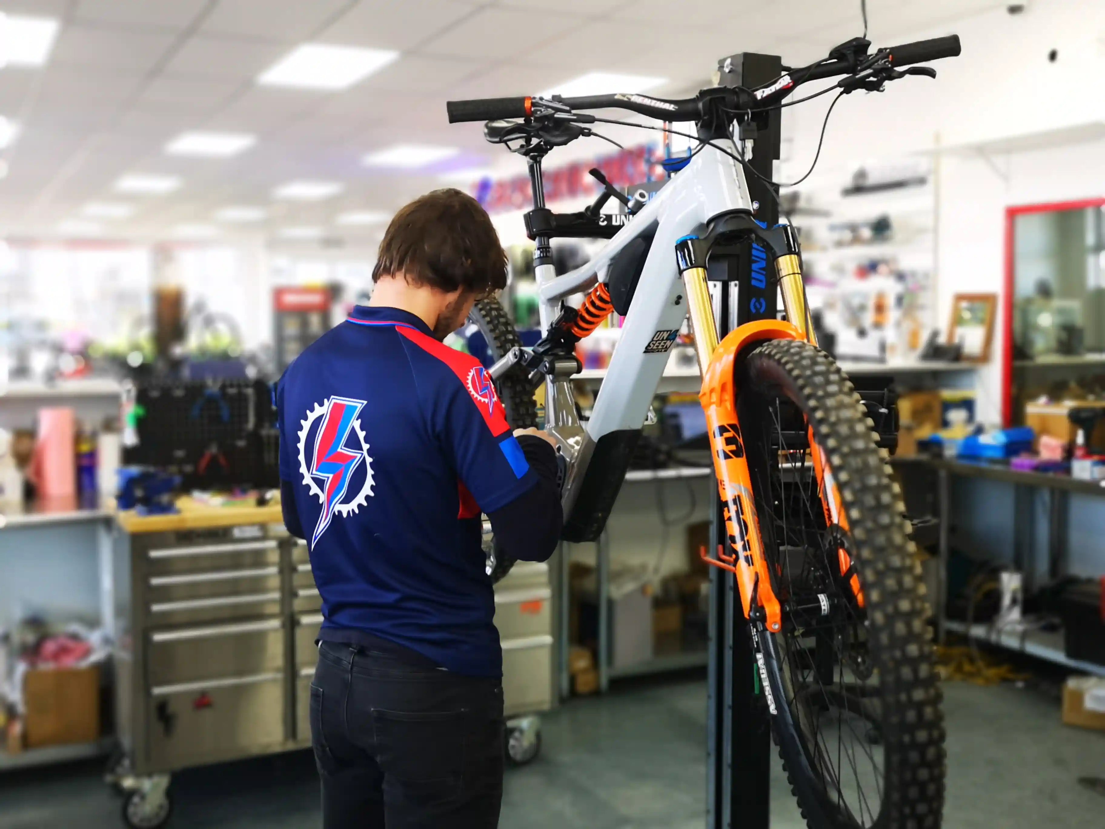 EBR bike mechanic working on an E-bike in a workshop setting