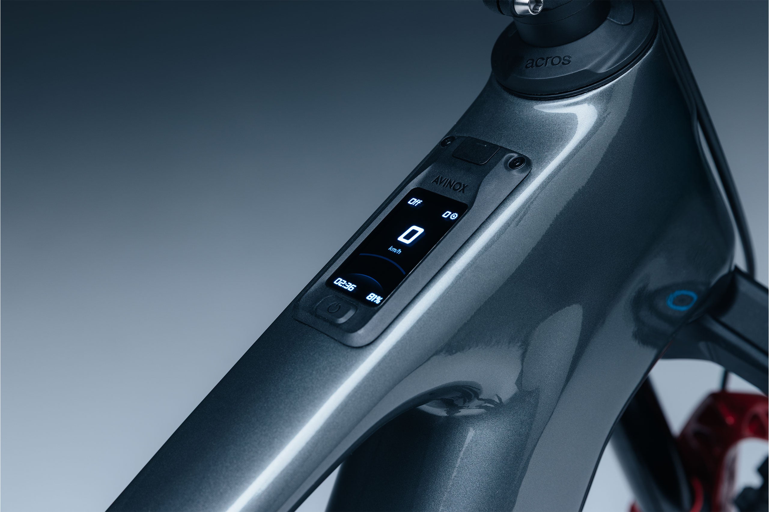 Close-up of Avinox 2” OLED Touch with control buttons on a gradient background