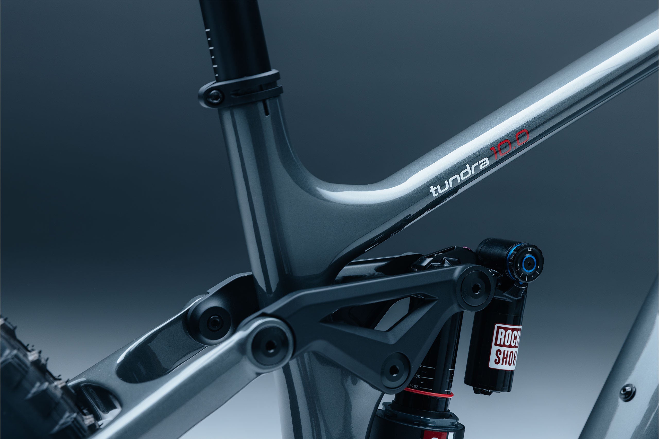 Close-up of a bicycle frame with 'tundra' branding on a dark background