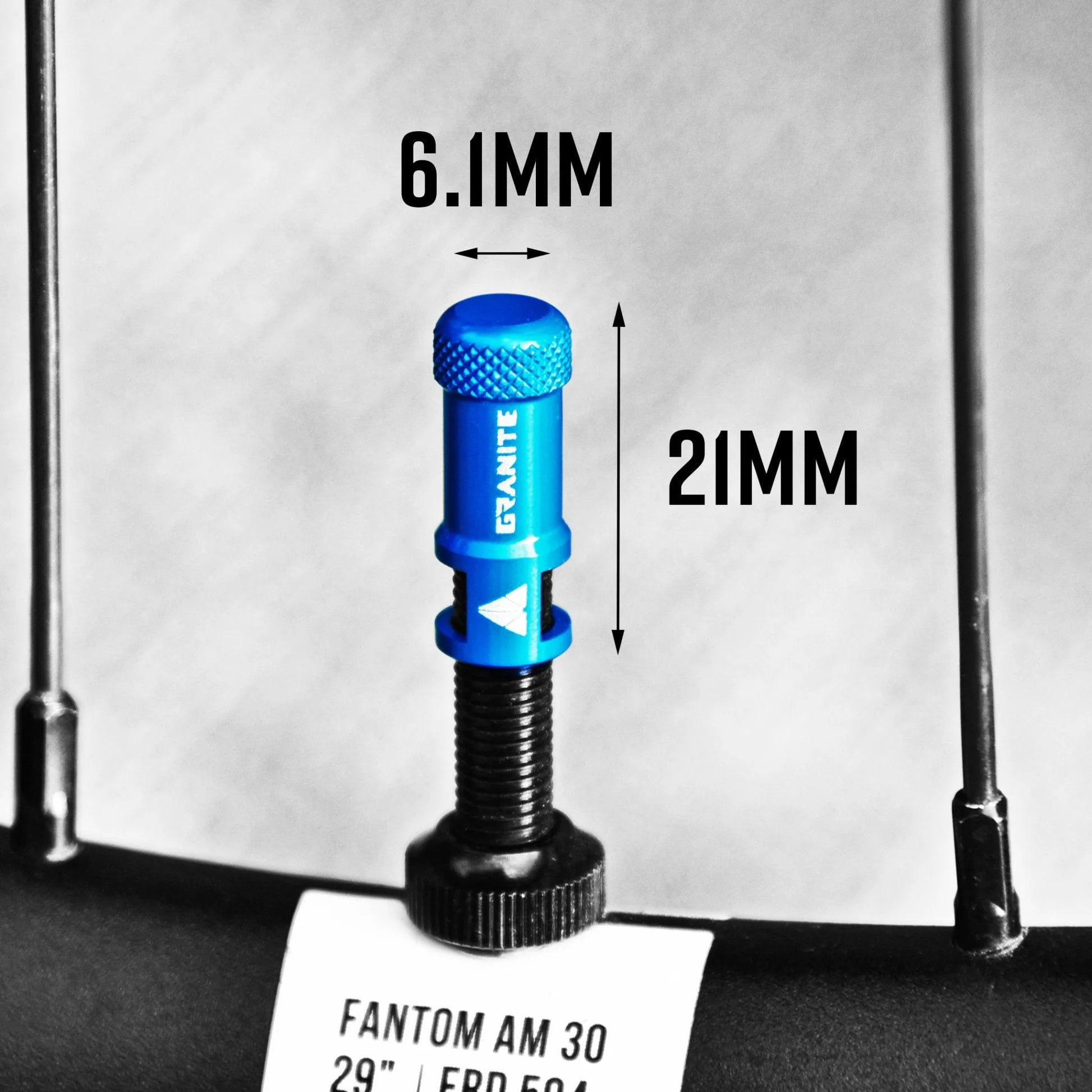 Blue bicycle valve core (Granite Designs Juicy Bike Nipple – Presta Valve Cap (Core Remover & Cap in-one) with measurements labeled on a white background