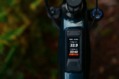 Digital Touch display on the Aventon Current with a blurred natural background