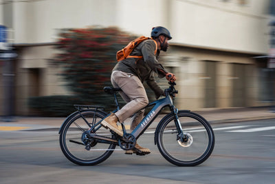 Men riding on the Aventon Level 3 E-Bike through the city