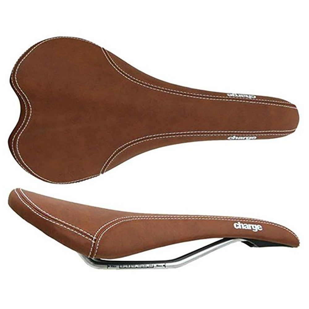 A brown Charge Spoon saddle with a steel rail, designed for mountain or road bicycles.