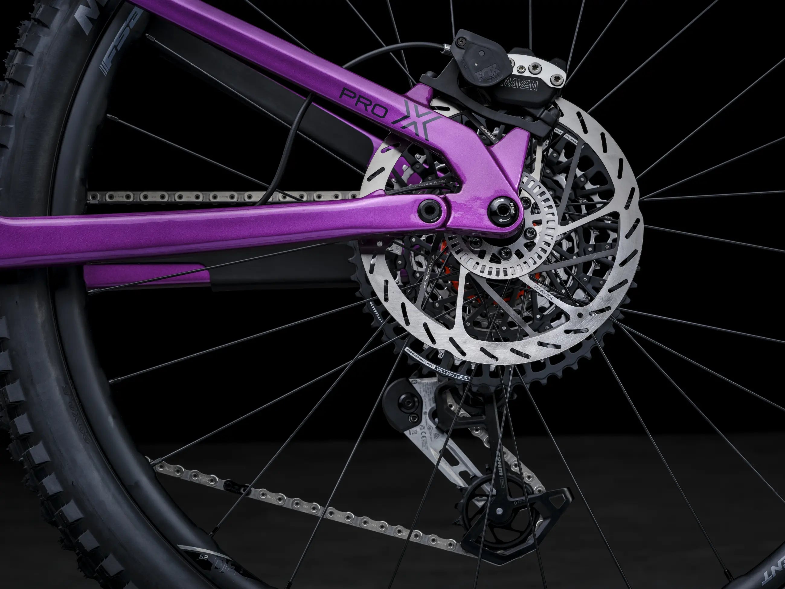 Close-up of Crussis e-Full 12.11 Pro X E-MTB Brakes with a purple frame on a black background
