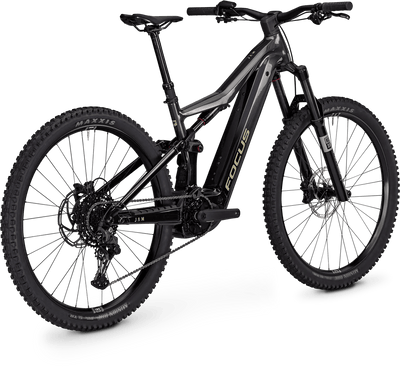 A black and dark gray Focus electric mountain bike with knobby tires, a front suspension fork, and a visible battery pack mounted on the frame, shown on a clean white background.