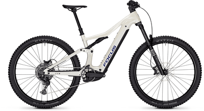 A Focus full-suspension mountain bike with a white frame, black suspension components, and black knobby tires, shown from a side profile on a white background.