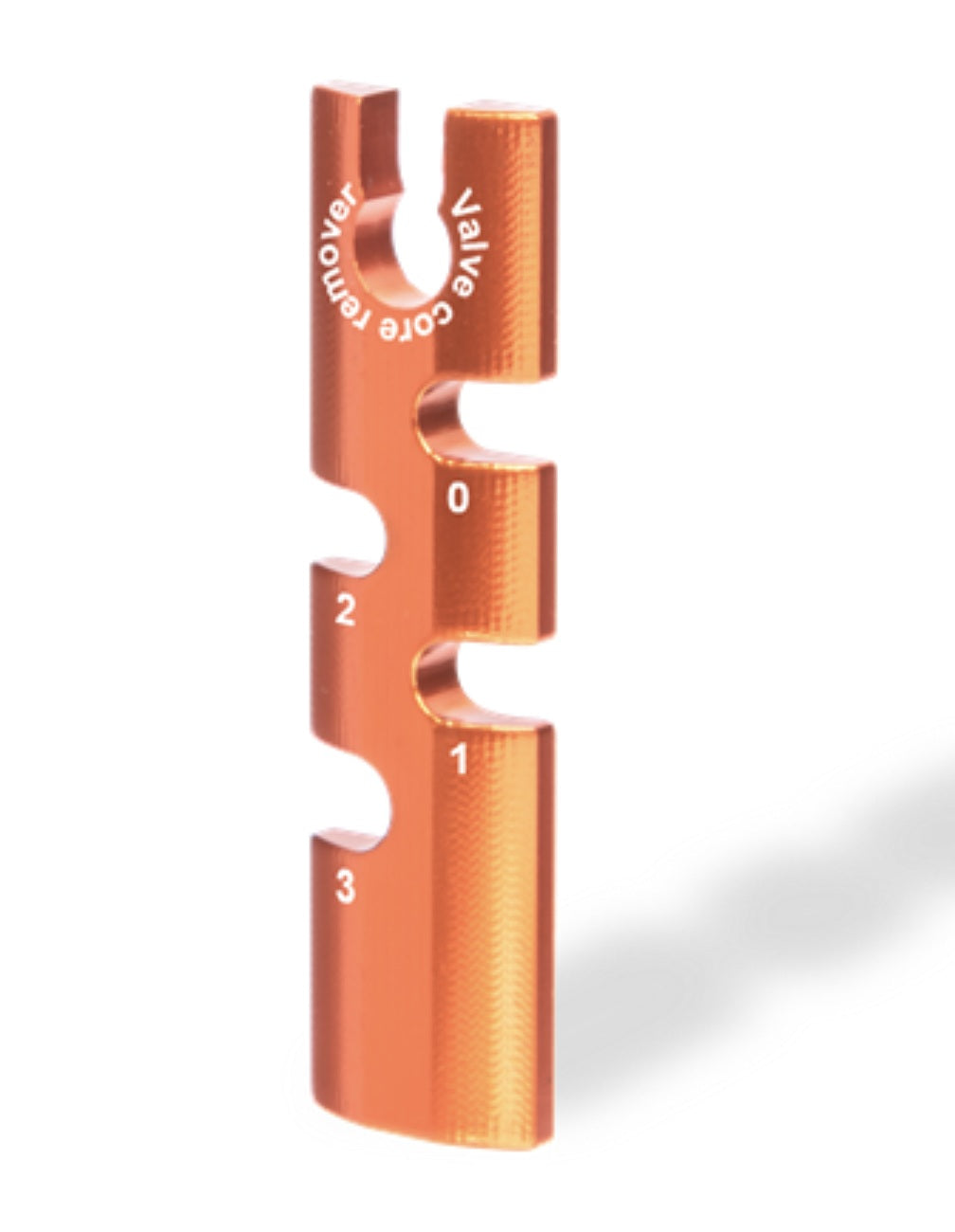 Orange valve core remover tool on a white background