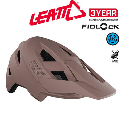 Pink bike helmet with Leatt logo and Fidlock features on a white background