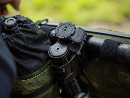 Close-up of Quad Lock Stem Cap Mount attached to stem with blurred natural background