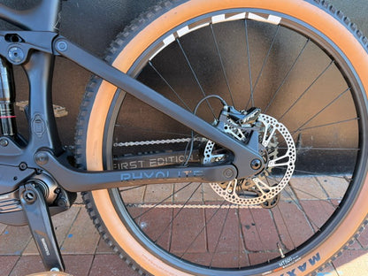 Close-up of a Rhyolite Base+ wheel with disc brake system on a paved surface