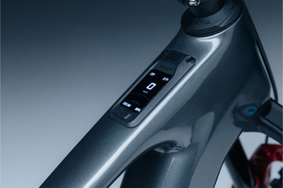 Close-up of Avinox 2” OLED Touch with control buttons on a gradient background