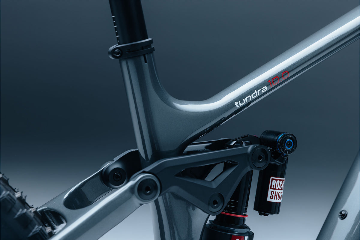 Close-up of a bicycle frame with 'tundra' branding on a dark background