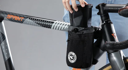 ULAC Cycling Bag attached to a bicycle with a person holding a cup.