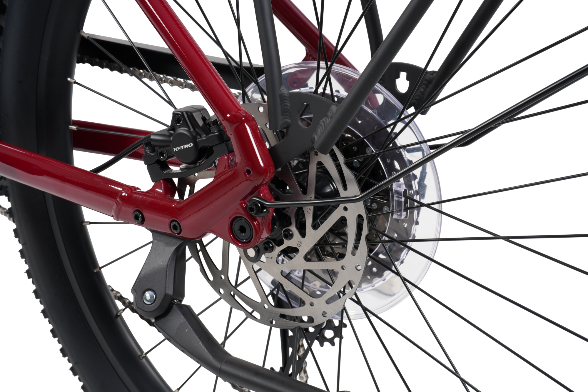 Close-up of a bicycle rear wheel showing a matte red frame, black spokes, a silver disc brake rotor, and a black tire against a white background.
