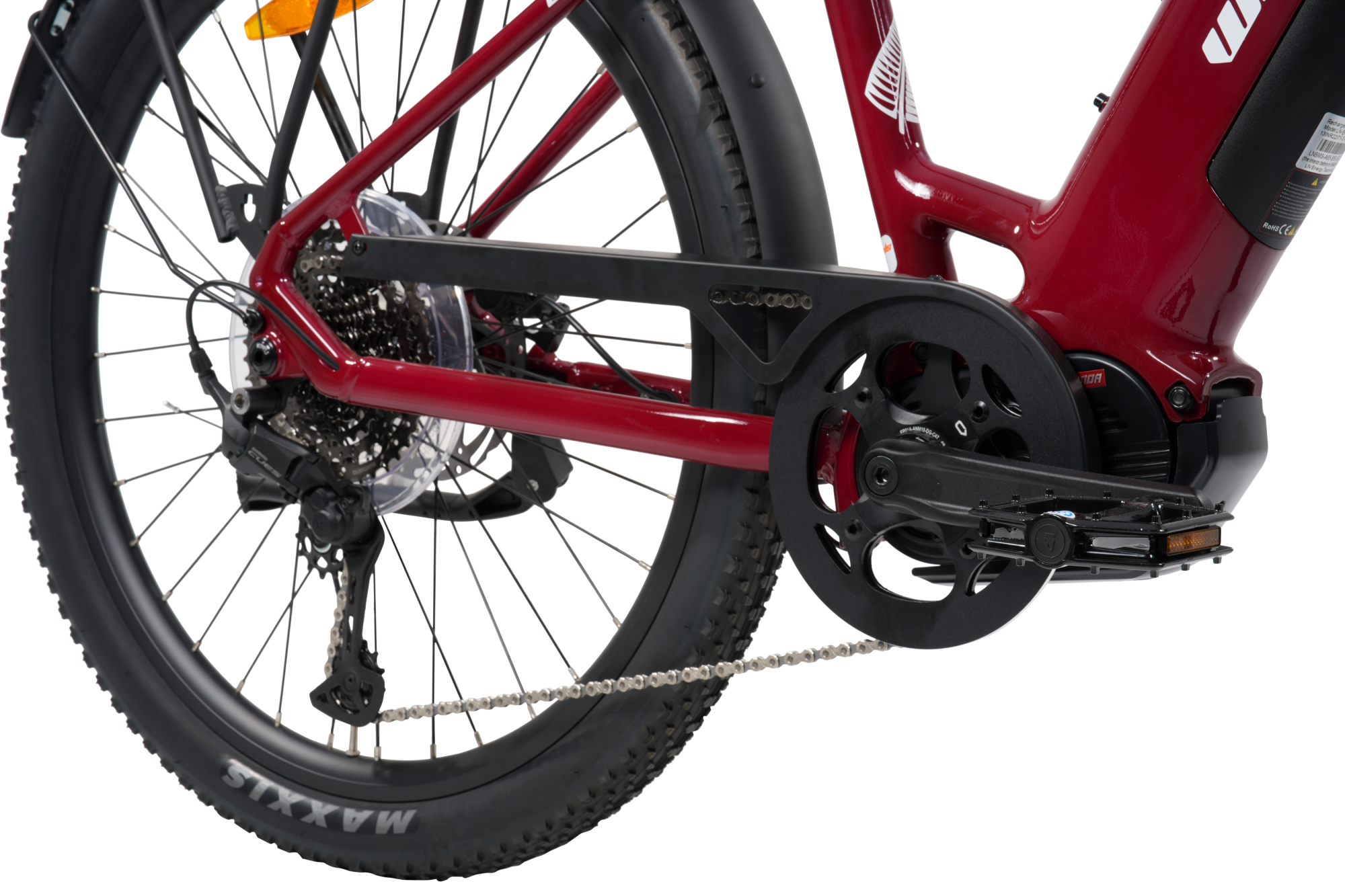 Close-up of a red electric bicycle showing the rear wheel, chain guard, chain, crankset, and part of the frame against a white background.