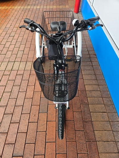 Bicycle with a basket on a brick pavement 