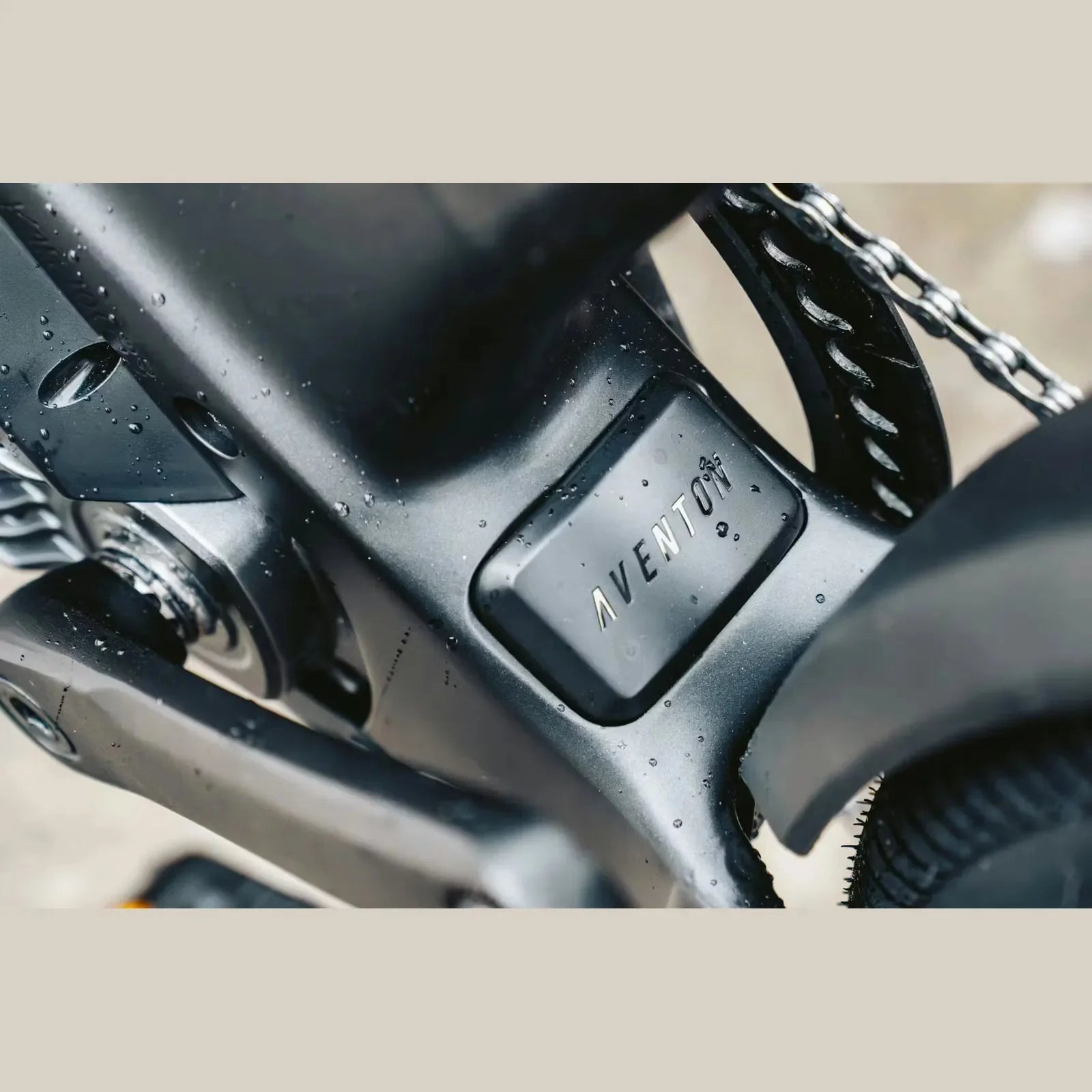 Close-up of Aventon ADV Ebike with 'Aventon' branding on a beige background